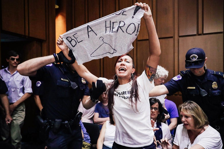 Capitol Police remove a protester from the hearing room during confirmation hearings for Brett Kavanaugh.